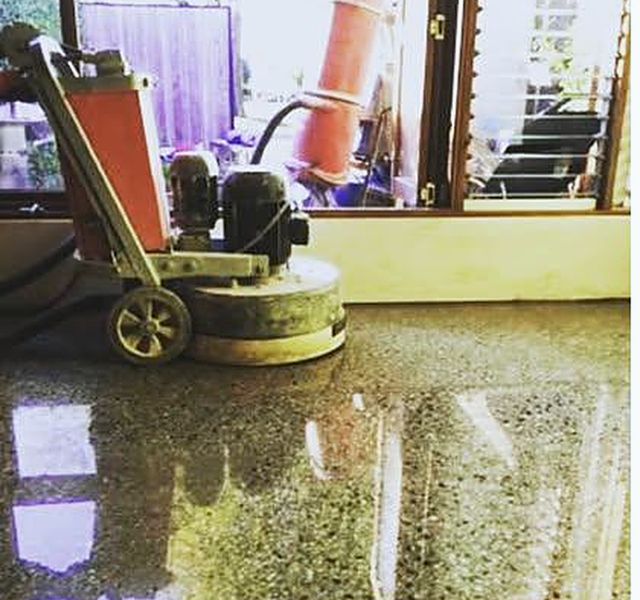Uneven concrete floor being ground and corrected