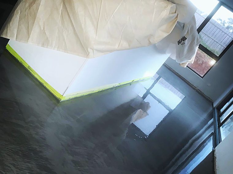 Flowing metallic epoxy floor through a doorway