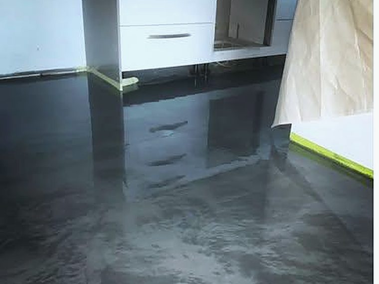 Dark metallic epoxy floor in a residential kitchen