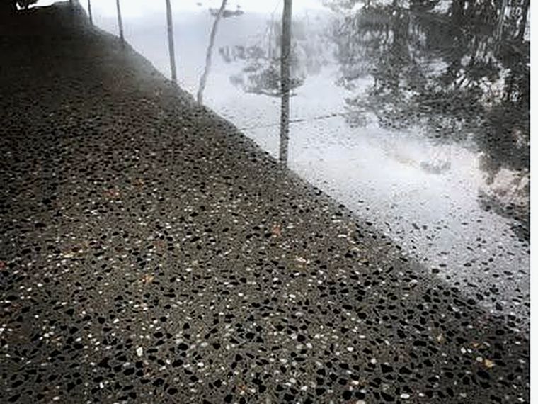 Representative exterior ground concrete walkway with a low sheen