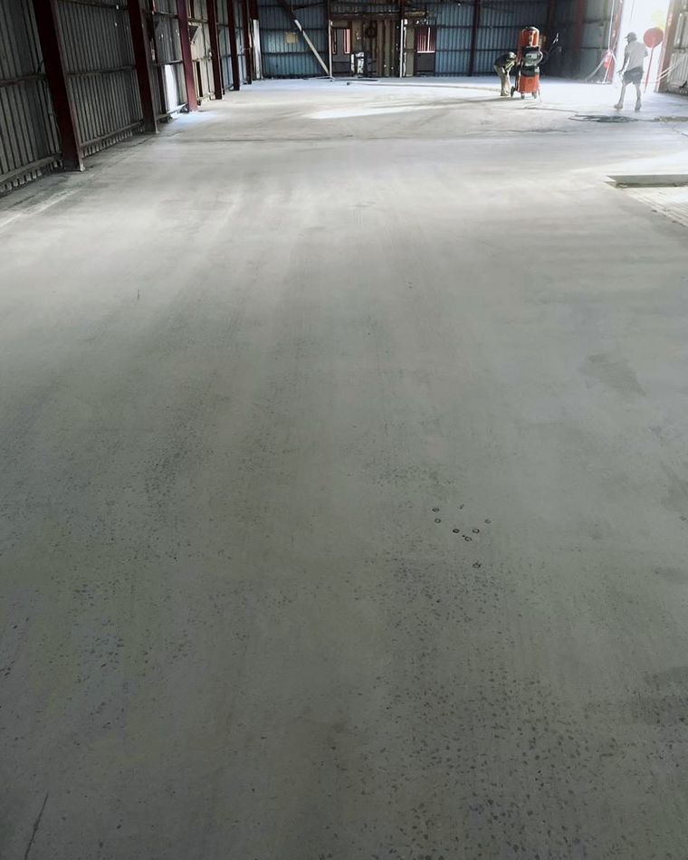 Warehouse concrete floor being ground back during preparation