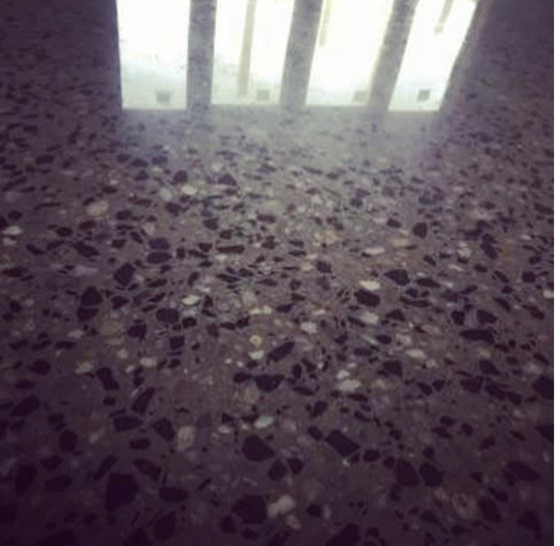 Representative ground and sealed concrete floor with a sealed satin finish reflecting overhead light