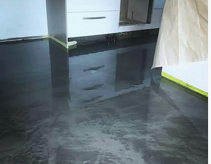 Dark metallic epoxy floor in a residential kitchen