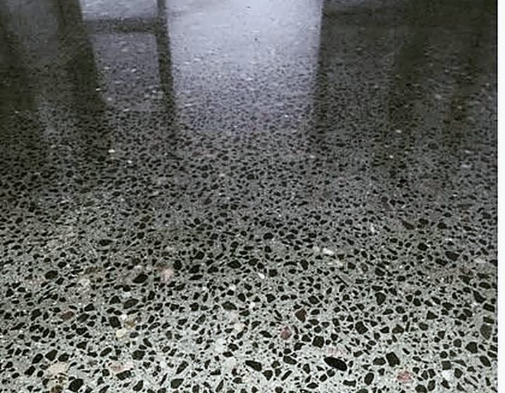 Close-up of aggregate-exposed polished concrete with high gloss